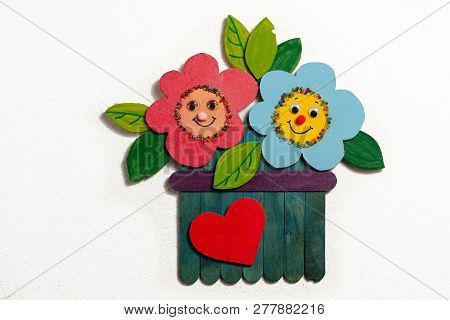 Colorful Figure Of Flowers In A Garden Made Of Wood By A Child, White Background