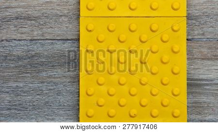 Top View Of Footpath Tiles On A Marble Texture Cover. Yellow Circle Buttons Pattern. A Stop Signal F