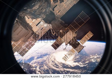 Collage Image With Planet Earth From The Outer Space From The Iss Window. Huge Hurricane. Elements O