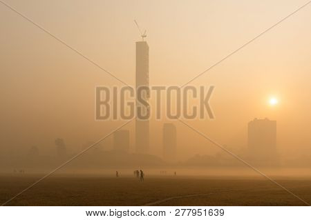 Beautiful Image Of Sunrise At Kolkata Maidan In A Foggy Winter Morning. Sunrises At The Horizon Abov