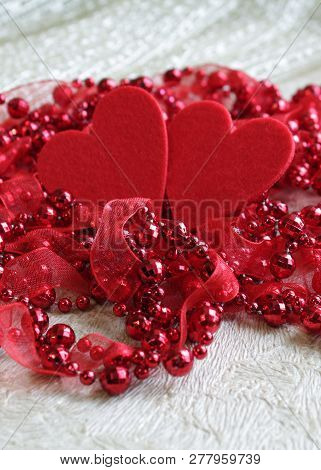 Background For Greeting Cards Of Love With Beads And Two Hearts, With The Effect Of Blur On A Light 