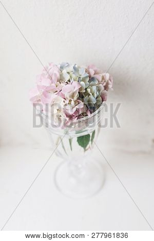 Countryside Still Life. Beautiful Hydrangea Flowers In Vintage Glass With Water On Rustic White Wood