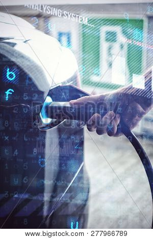 Virus background against man charging electric car at charging station