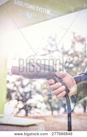 Virus background against man holding charging plug