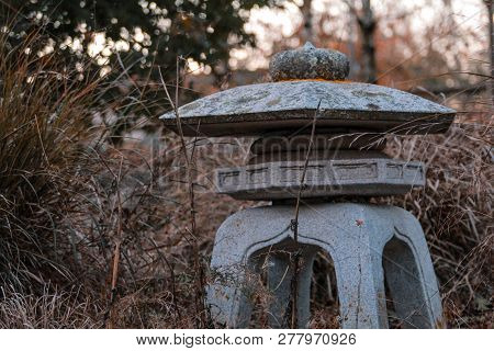 Little Stone Statue In Public Park, New Zealand