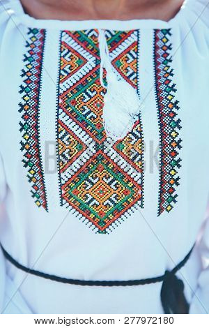 Beautiful Young Woman In Traditional Ethnic Ukrainian  Style. Vyshivanka Blue With White Embroidery