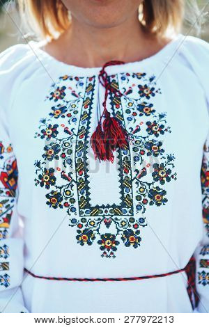 Beautiful Young Woman In Traditional Ethnic Ukrainian  Style. Vyshivanka Blue With White Embroidery