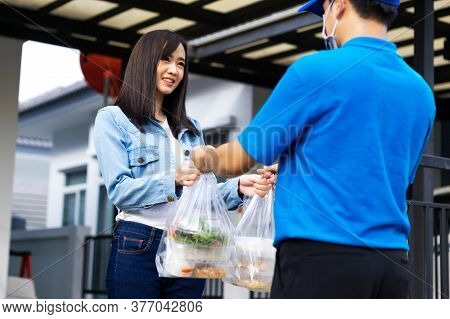 Asian Delivery Man Delivering Food, Fruit, Joice And Vegetable To Customer Home - Online Grocery Sho