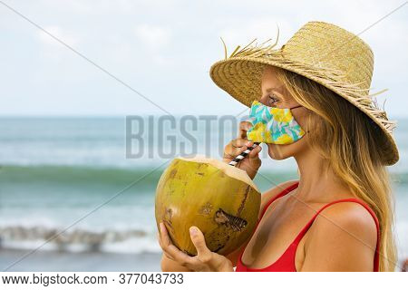 Funny Portrait Of Woman In Straw Hat Drinking Young Coconut On Tropical Sea Beach. New Rules To Wear