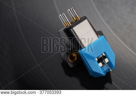 A Magnetic Phono Cartridge On Vinyl Record Disk. Macro Photo.