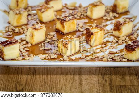 Traditional Cheese From Brazil, Called Queijo Coalho . Served With Cane Molasses. On Wooden Table.
