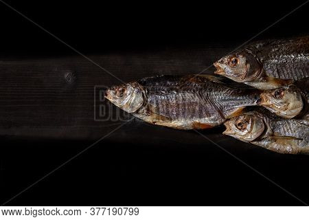 Dried Or Jerky Salted Taranka, Tasty Clipfish On Wooden Background. Beer Snack. Traditional Way Of P