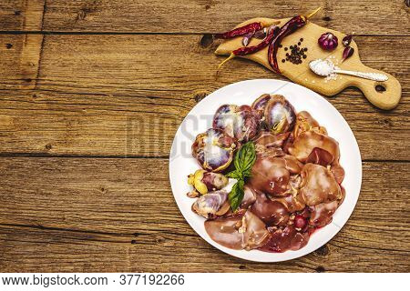 Fresh Raw Chicken Offal: Heart, Liver, Stomach With Dry Spices, Sea Salt, Chili Pepper On Wooden Tab