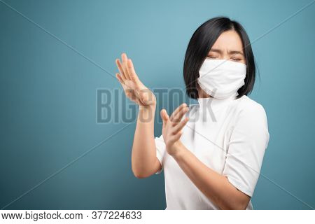 Don't Touch Me. Asian Woman Wearing Hygiene Mask Panic And Disguted Showing Hand Stop Sign And Stand