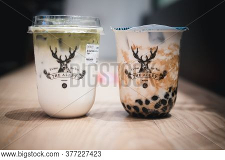 Samut Prakan, Thailand - July 20, 2020 : Bubble Milk Tea And Latte Green Tea In A Plastic Glass On T