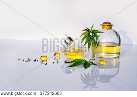 Glass Bottle With Cbd Oil, Thc Tincture And Hemp Leaves On White Background Lab. Medical Marijuana P