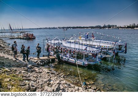 Luxor, Egypt - Jan 28, 2020: Touristis enter in boats on the Nile river in Luxor city, Egypt
