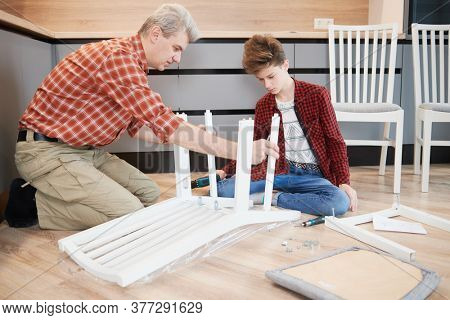 father and son work together. kitchen furniture chair assembling