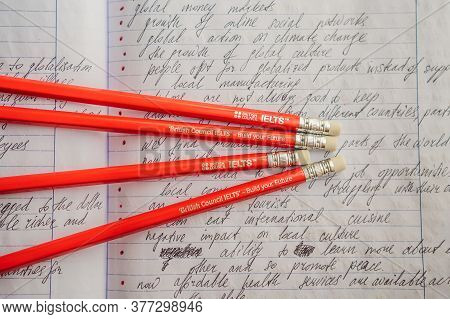 Vietnam, Nha Trang, 14.07.2020: Ielts Red Pencils And Essay Notebook For The English Exam