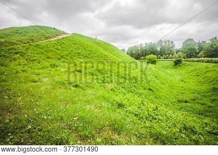 Green Grass Hill And Cloudy Sky. Simple Scenic Landscape