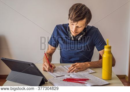 Vietnam, Nha Trang, 14.07.2020: A Man Prepares For The Ielts Exam Ielts Red Pencils, Reading Text An