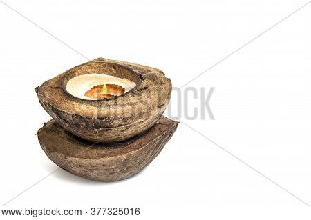 Candle In Coconut On A White Background