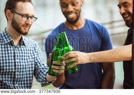 Group Of Happy Friends Having Beer Party In Summer Day. Resting Together Outdoor, Celebrating And Re