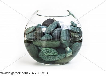 Sea Stones Turquoise In A Glass Vase Full Of Water On A White Background