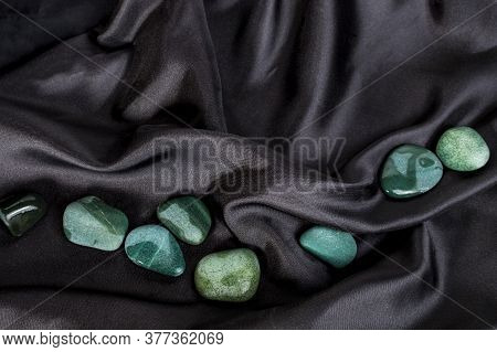 Black Fabric With Blue And Green Sea Stones On It