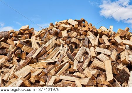 Huge Pile Of Firewood Chocks Against The Sky Close-up