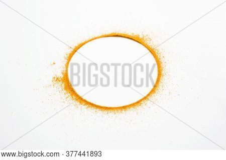 Turmeric Or Haldi Powder On The White Background Forming Ring Shape.