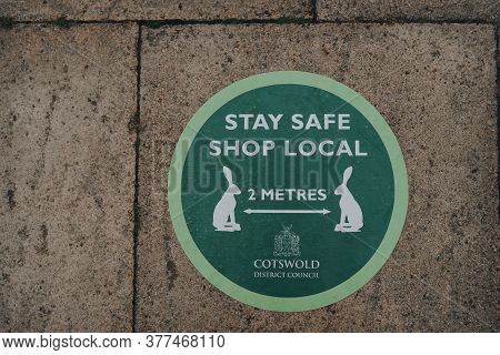 Stow-on-the-wold, Uk - July 6, 2020: Stay Safe Shop Local And 2 Metres Social Distancing Green Sign 