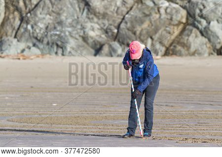 Drawing A Labyrinth On The Beach