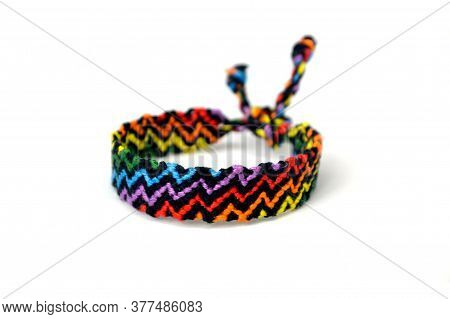 Selective Focus Of Tied Woven Friendship Bracelet With Bright Colorful Pattern Handmade Of Thread Is
