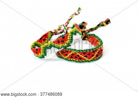 Selective Focus Of Tied Woven Friendship Bracelets With Watermelon Pattern Handmade Of Thread Isolat