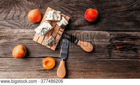 Tasty Blue Cheese With Peaches Fruit On A Wooden Background. Dorblu Cheese Pieces, Danish Blue Chees