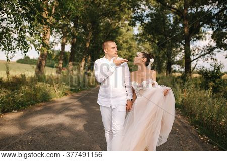 Goom And Bride Walkin In The Park In Wedding Day. Summmer Wedding