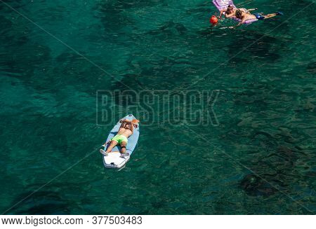 Polignano, Italy - September 17, 2019: People Relax And Swimming On Lovely Beach Lama Monachile In P