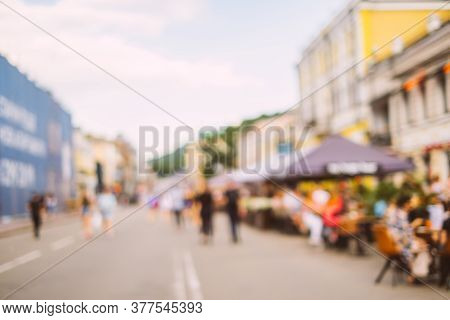 Blurred Background With Group Of Peolple Sitting At The Cafe Veranda Outside.