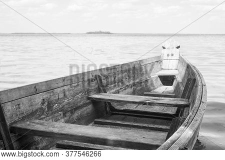 Black And White Photo Of A Boat On The Lake