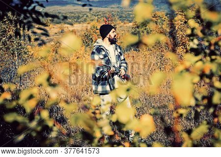 Hunter With Shotgun Gun On Hunt. Poacher With Rifle Spotting Some Deers. Illegal Hunting Poacher In 