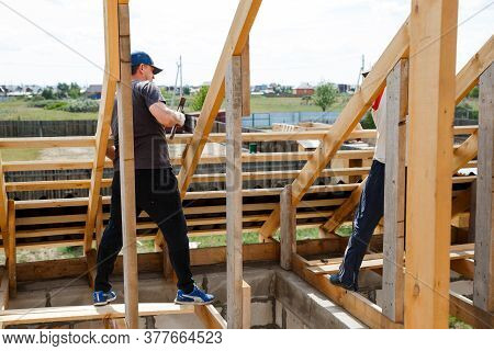 Fasteners And Installation Of Roof Rafters By Workers. Preparation For Laying Slate. Construction An
