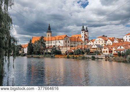 Telc City With Dramatic Sky. Water Reflection Of Houses And Telc Castle, Czech Republic. Unesco Worl