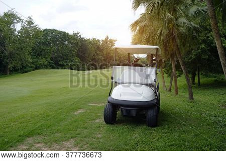 Golfcar On Beautiful Golf Course In The Evening Golf Course With Fresh Green Grass Field And Cloud S