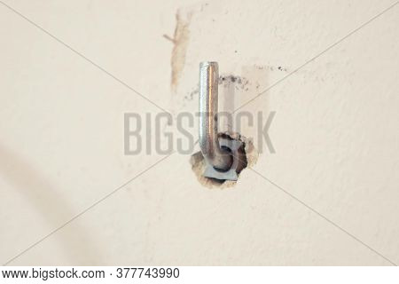 A Nail Driven Not Completely Into A Light Wall.