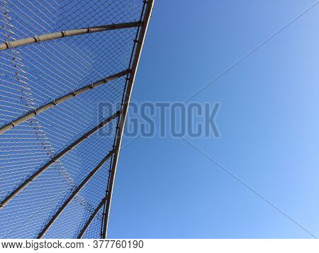 Geometric Design Element Chain Link Baseball Backstop Fence And Blue Sky