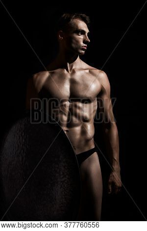 Front View Of Young Fit Strong Warrior With Perfect Muscular Body. Tensed Athlete In Underwear Looki
