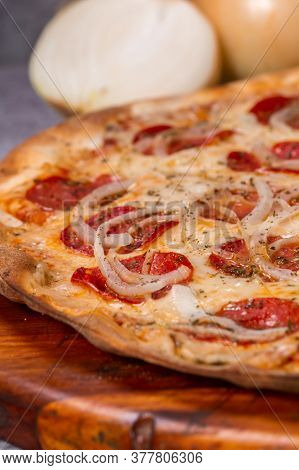 Pepperoni Pizza On Gray Background. Brazilian Pizza Called Pizza De Calabresa.
