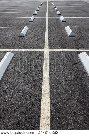 Empty Parking Lot With Lines And Stop Blocks