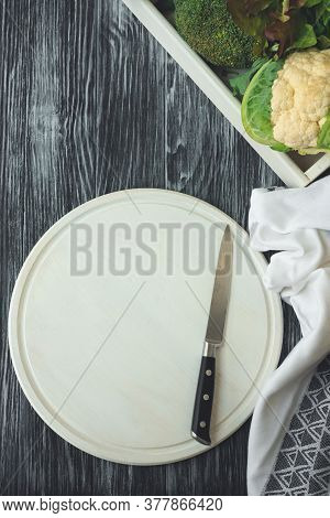 Empty White Cutting Board With Knife On Dark Rustic Background. Flat Lay. Top View. Mock-up